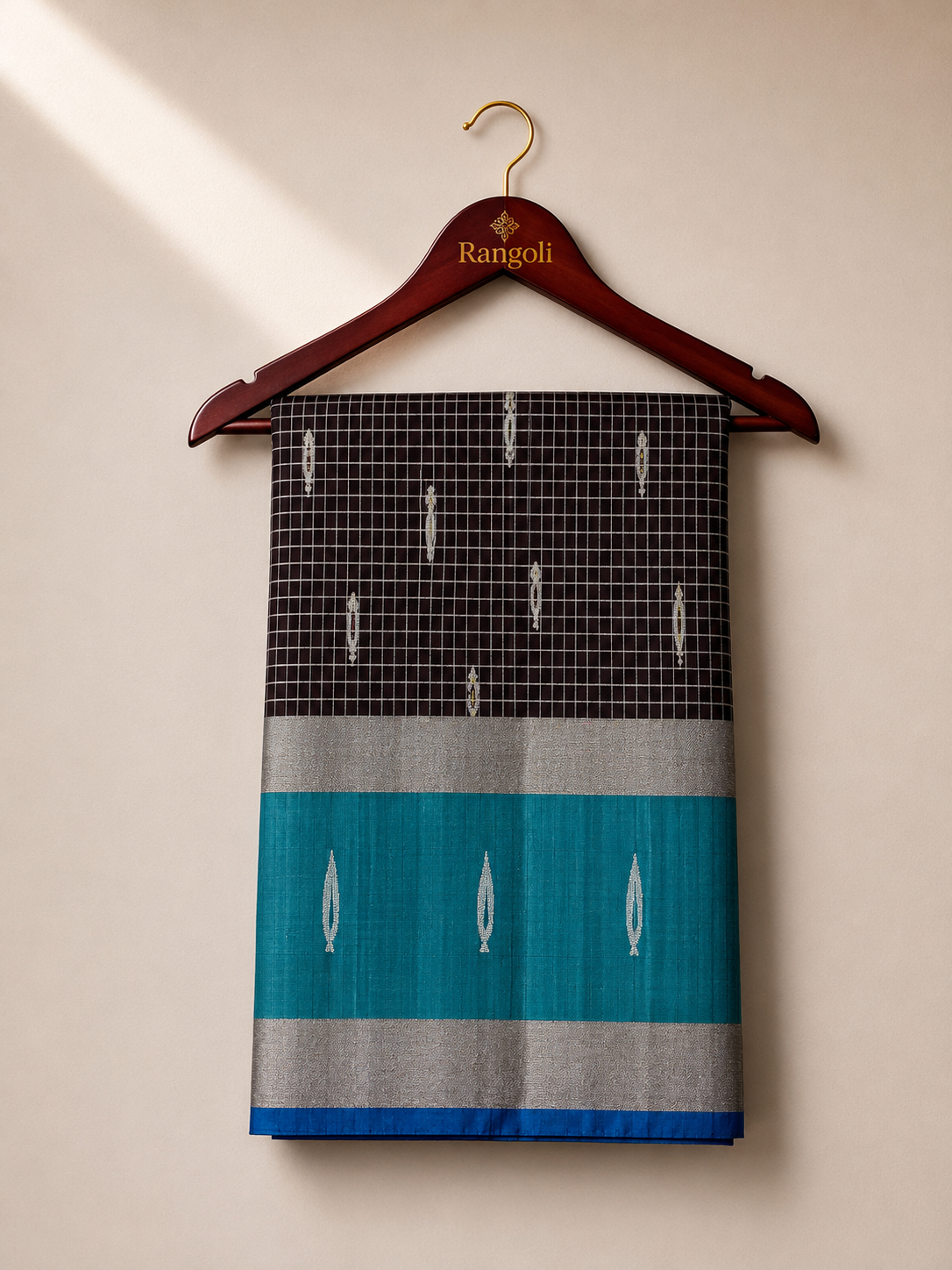 Elevate your ethnic elegance with this sophisticated black silk saree, featuring a teal contrast border with shimmering silver zari for a timeless traditional appeal.