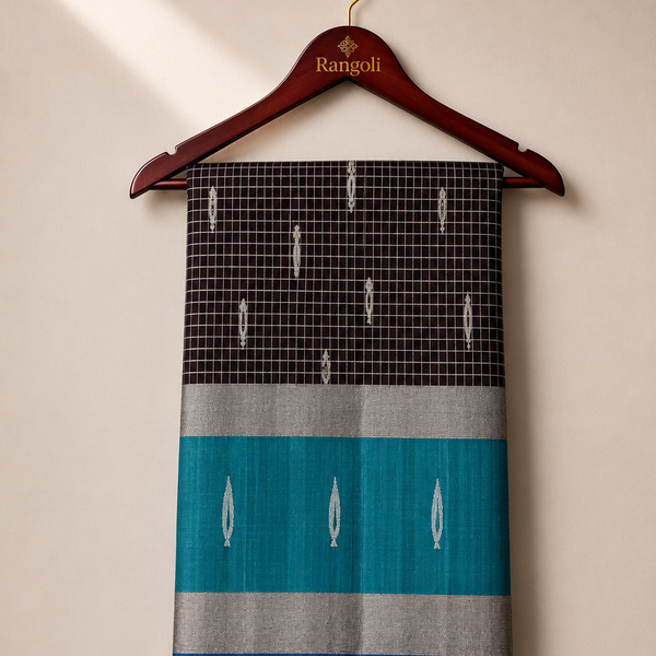 Elevate your ethnic elegance with this sophisticated black silk saree, featuring a teal contrast border with shimmering silver zari for a timeless traditional appeal.