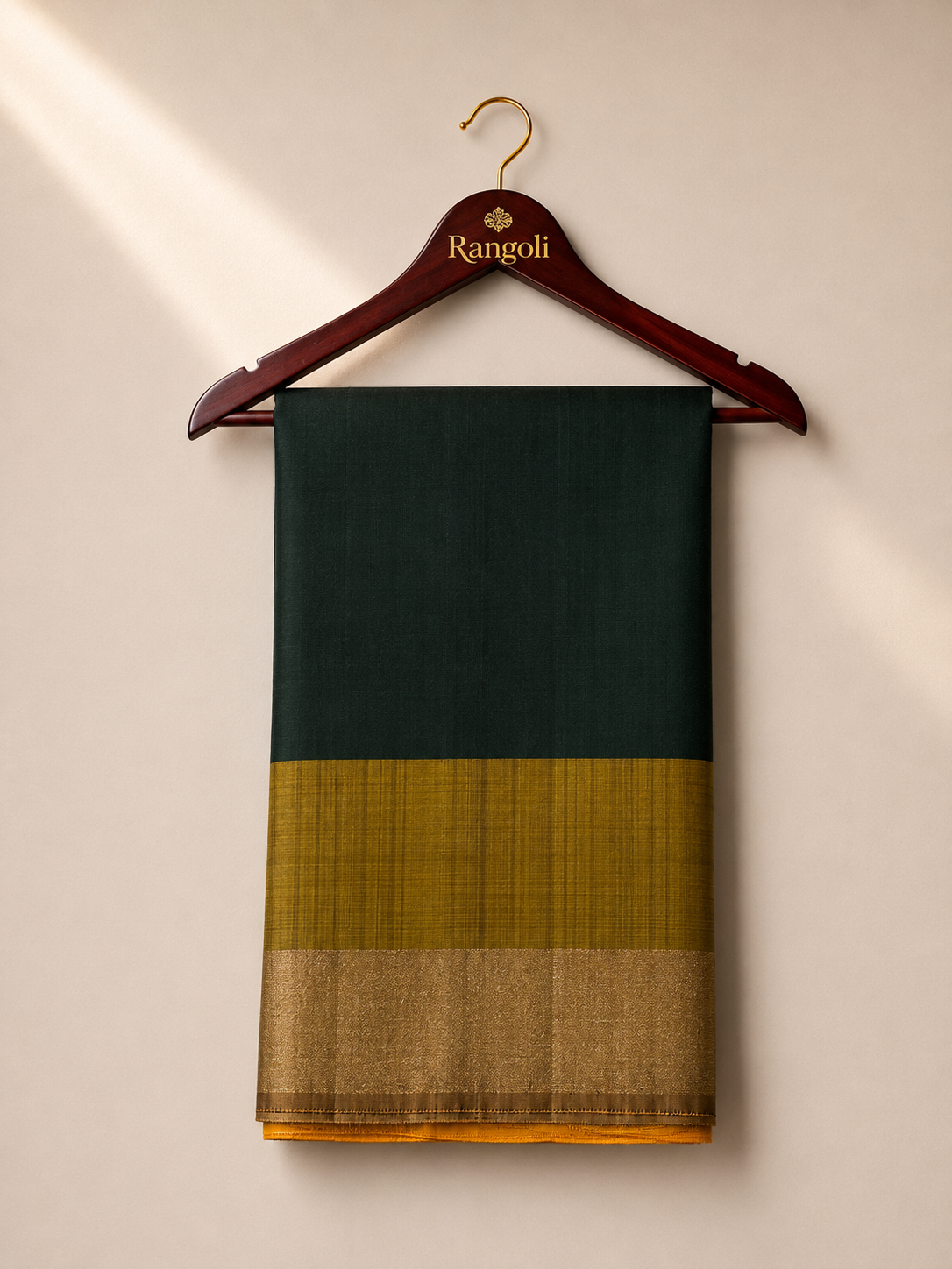 Embrace timeless elegance with this rich dark green silk saree, beautifully finished with a lustrous gold zari contrast border for a graceful traditional look.