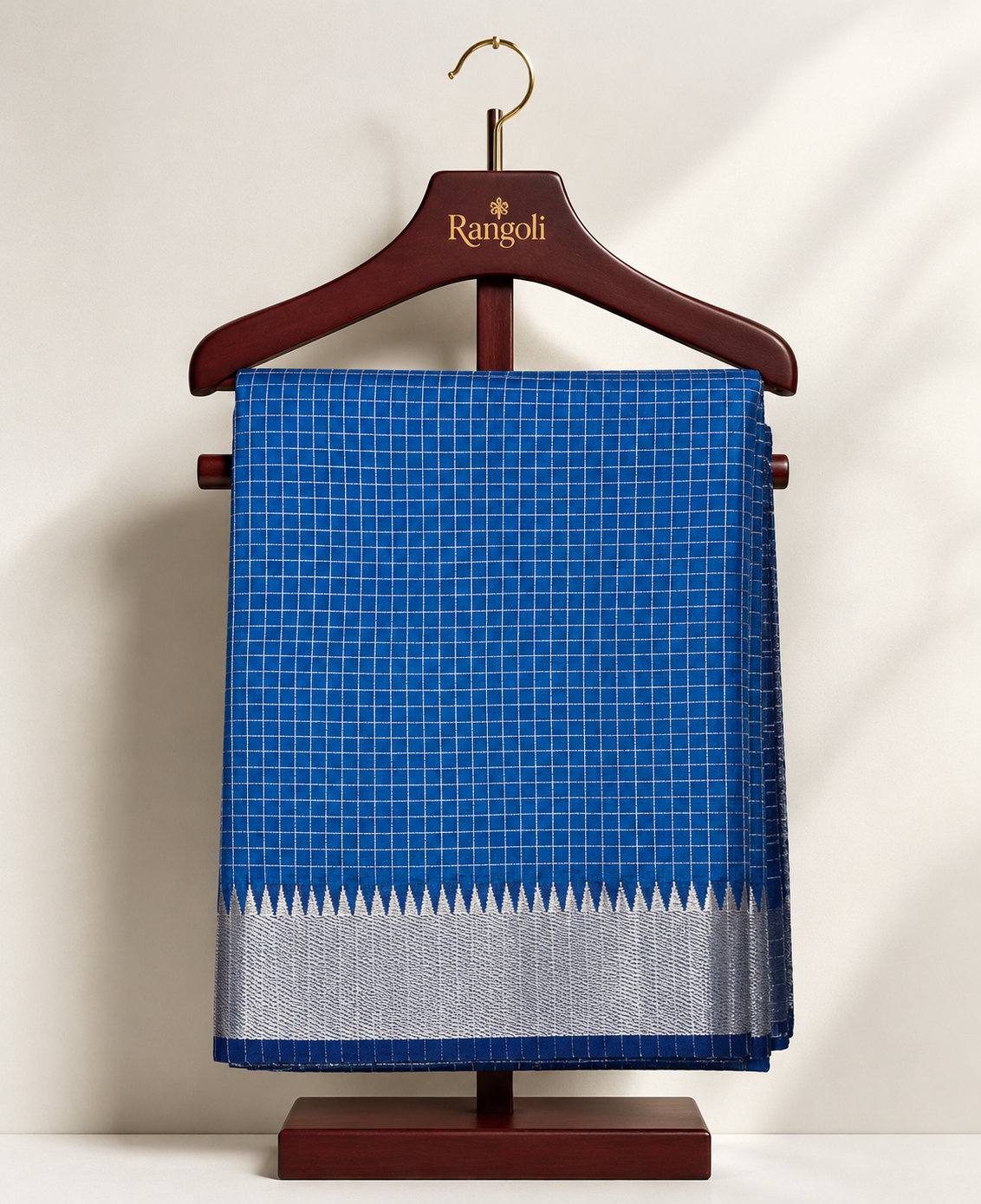 Elegant royal blue checked saree with a rich silver zari border, blending timeless tradition with understated sophistication.