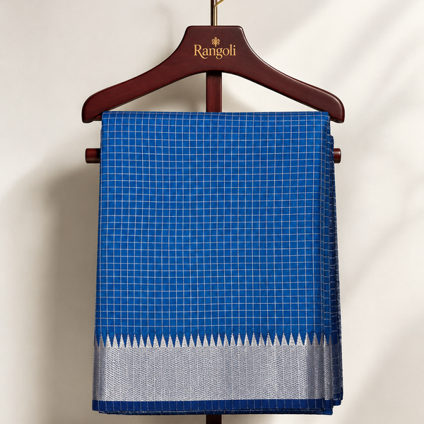 Elegant royal blue checked saree with a rich silver zari border, blending timeless tradition with understated sophistication.