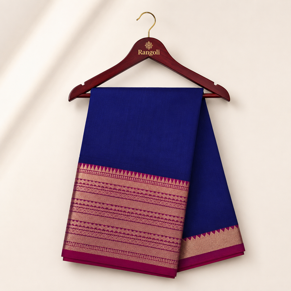 Royal blue silk saree featuring a rich magenta and gold zari woven border for a graceful traditional look.
