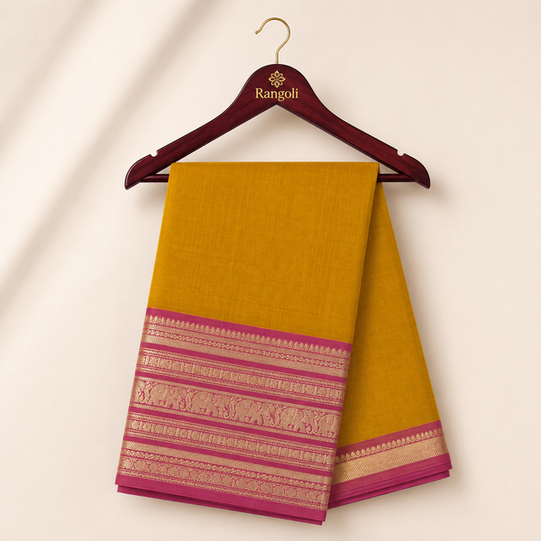 Mustard yellow silk saree featuring a rich magenta and gold zari woven border with elegant traditional elephant motifs for a graceful festive look.