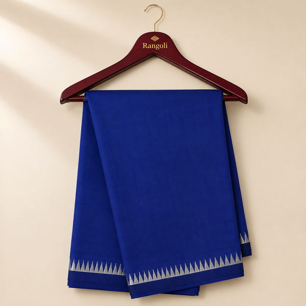 Royal blue saree featuring a sleek silver zari woven border, offering a perfect blend of timeless elegance and understated charm.