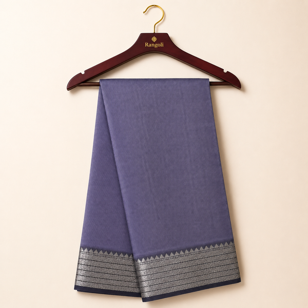 Elegant lavender silk saree with a finely woven texture and a shimmering silver zari border for a timeless traditional look.