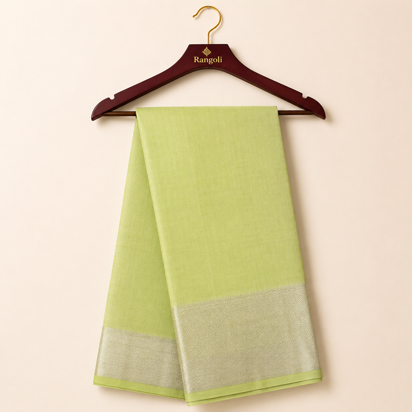 Elegant lime green silk saree featuring a lustrous silver zari border for a fresh, graceful, and timeless ethnic look.