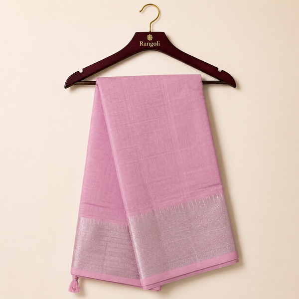 Elegant pastel pink silk saree featuring a subtle woven texture and a lustrous silver zari border for a graceful and timeless ethnic look.