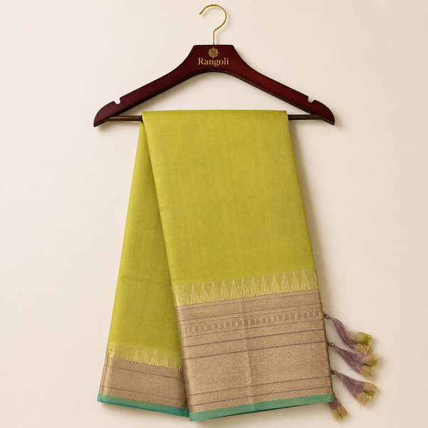 Elegant olive green silk saree featuring a rich gold zari border with a contrasting aqua blue edge for a graceful and timeless traditional look.