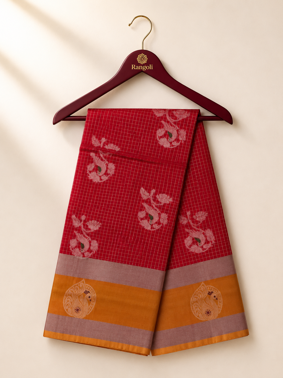 Elegant ruby red silk saree featuring intricate zari motifs with a rich mustard gold and silver zari border for a classic festive look.