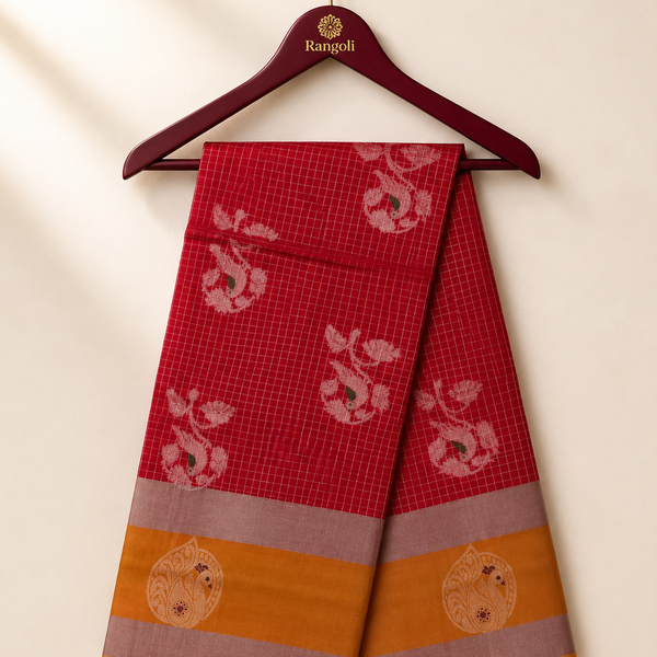 Elegant ruby red silk saree featuring intricate zari motifs with a rich mustard gold and silver zari border for a classic festive look.