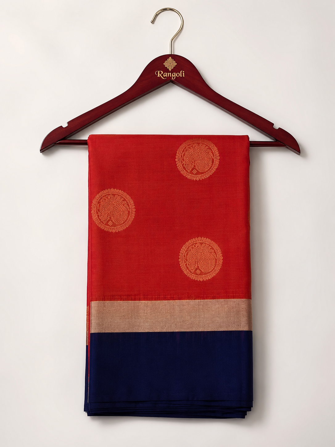 Graceful orange Kanchipattu silk saree featuring elegant gold zari buttas with a rich navy blue zari border for a timeless traditional look.