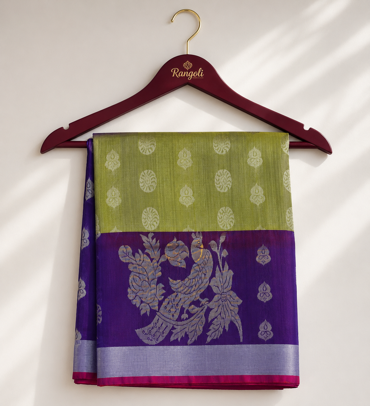 Olive Green Kanchipattu Silk Saree featuring elegant silver zari buttas with a rich purple peacock zari border for a timeless traditional look.