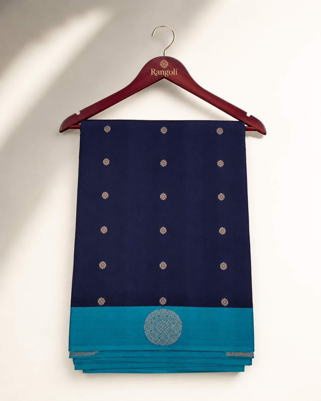 Navy blue silk saree featuring elegant gold woven butta motifs with a striking teal contrast border for a timeless traditional look.
