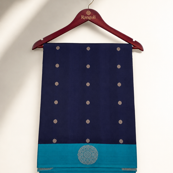 Navy blue silk saree featuring elegant gold woven butta motifs with a striking teal contrast border for a timeless traditional look.