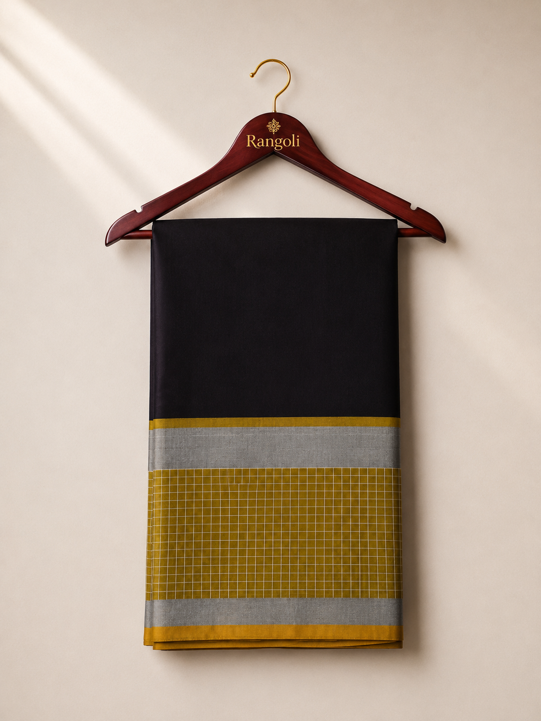 Make a sophisticated statement with this elegant black silk saree, beautifully complemented by a mustard checked border and shimmering silver zari accents.