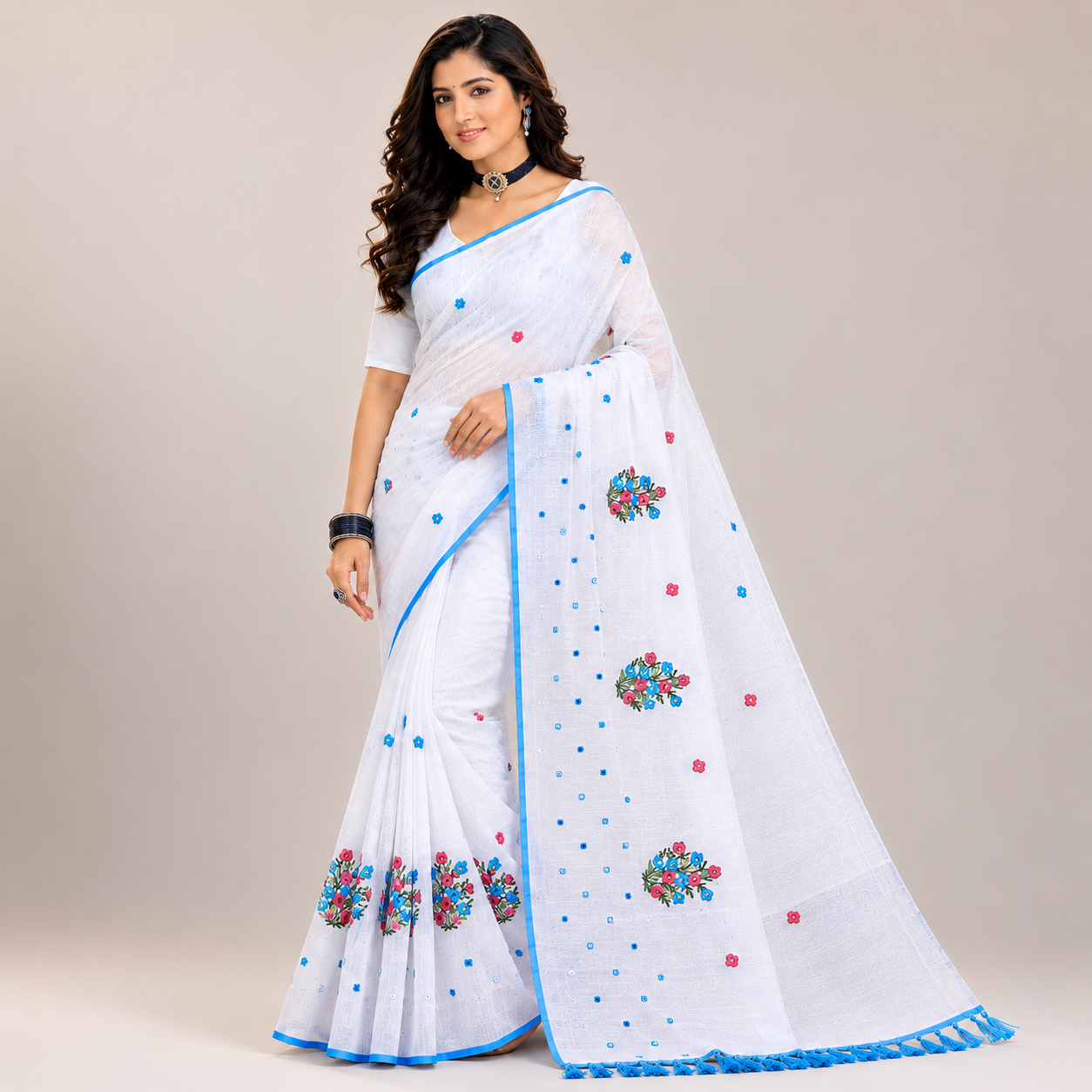 Elegant white saree featuring delicate floral embroidery and a refreshing sky-blue border for a graceful and timeless ethnic look.