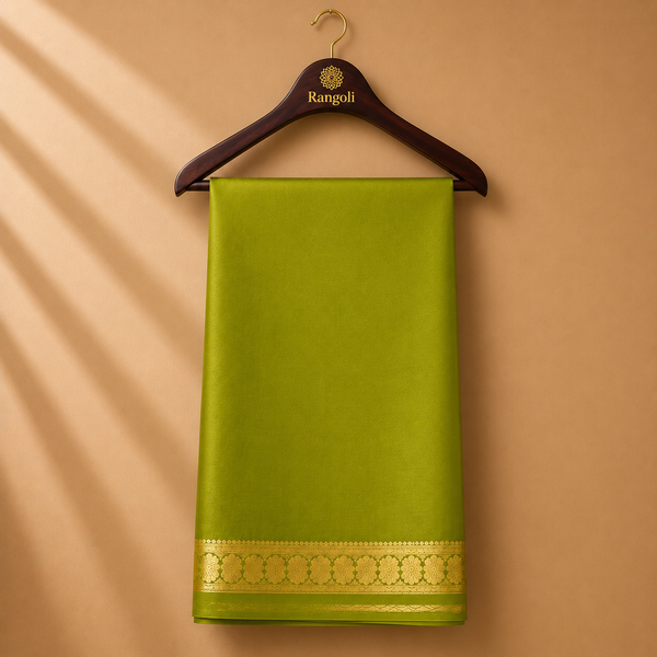 Vibrant olive green Mysore Silk saree featuring a lustrous finish and an elegant gold zari floral border.