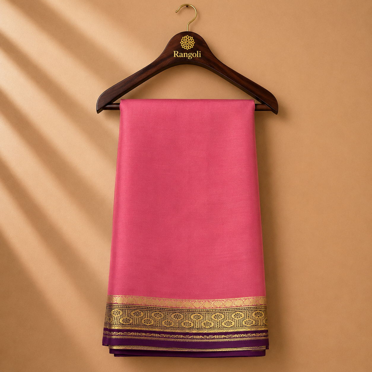 Graceful salmon pink Mysore Silk saree featuring a rich gold zari border with deep purple accents.