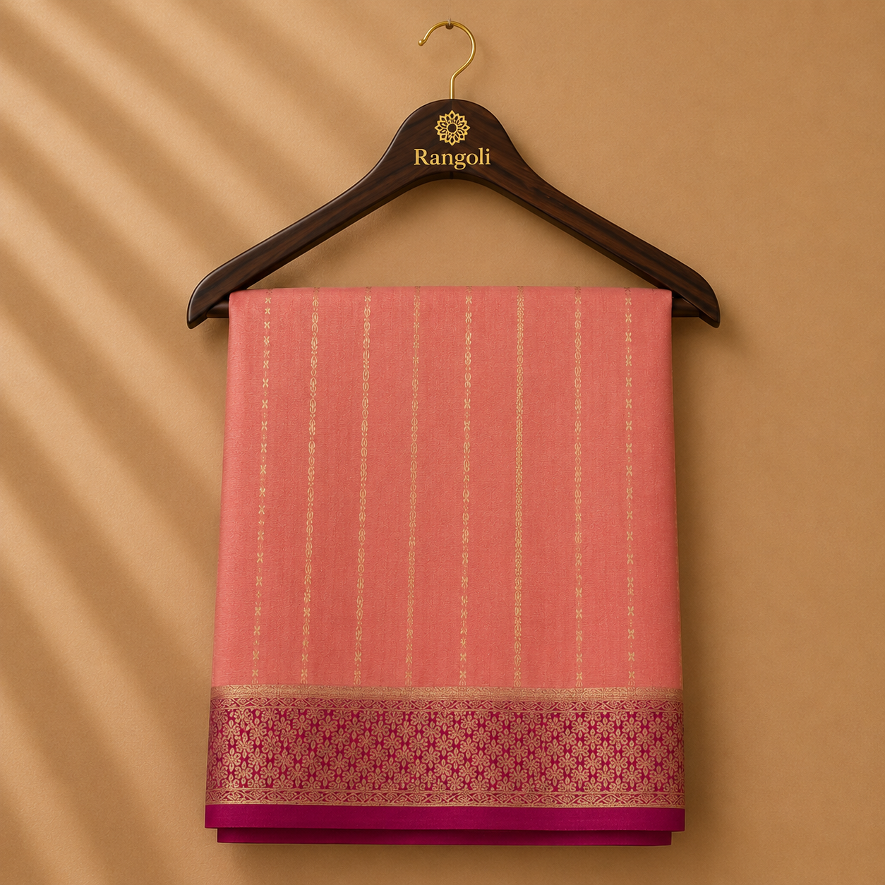 Graceful peach pink Mysore silk saree featuring delicate gold zari stripe weaving and a rich magenta zari border for timeless elegance.