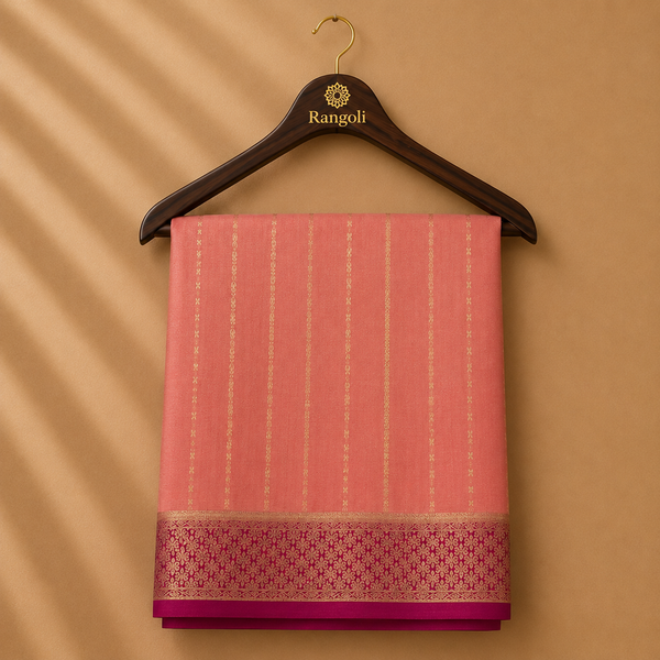 Graceful peach pink Mysore silk saree featuring delicate gold zari stripe weaving and a rich magenta zari border for timeless elegance.