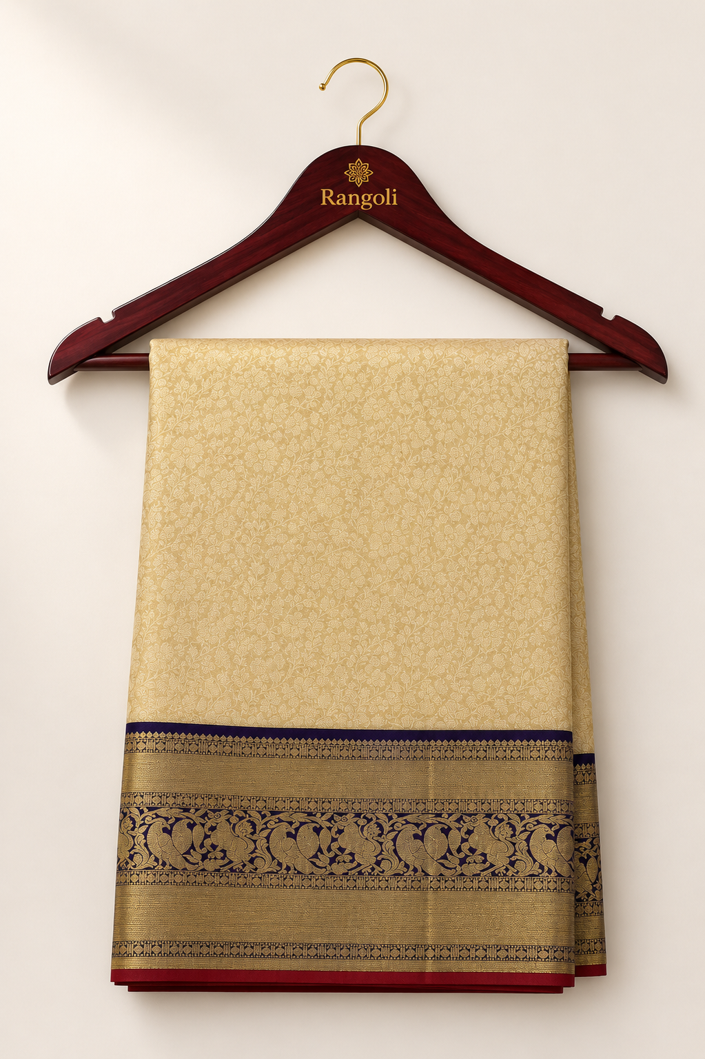 Kanchipattu cream gold saree with intricate floral weaving and a regal navy blue zari border for a luxurious traditional look