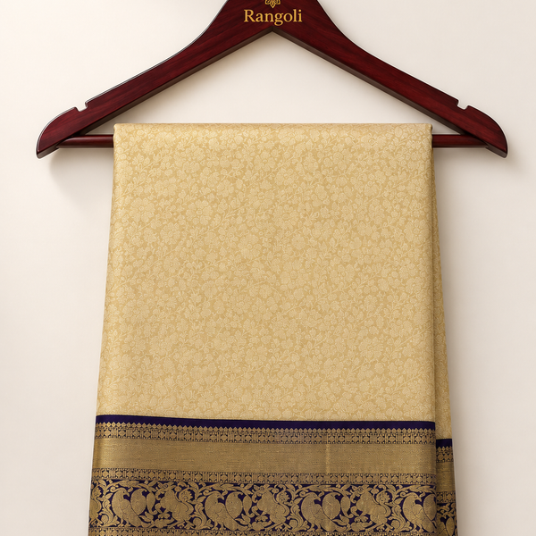 Kanchipattu cream gold saree with intricate floral weaving and a regal navy blue zari border for a luxurious traditional look