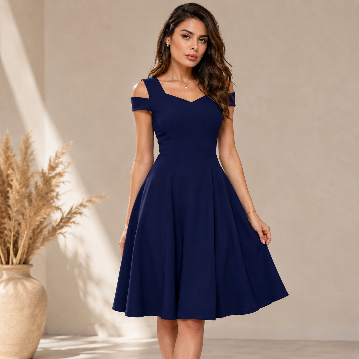 Elegant navy blue fit-and-flare dress featuring a stylish cold-shoulder neckline and graceful feminine silhouette.