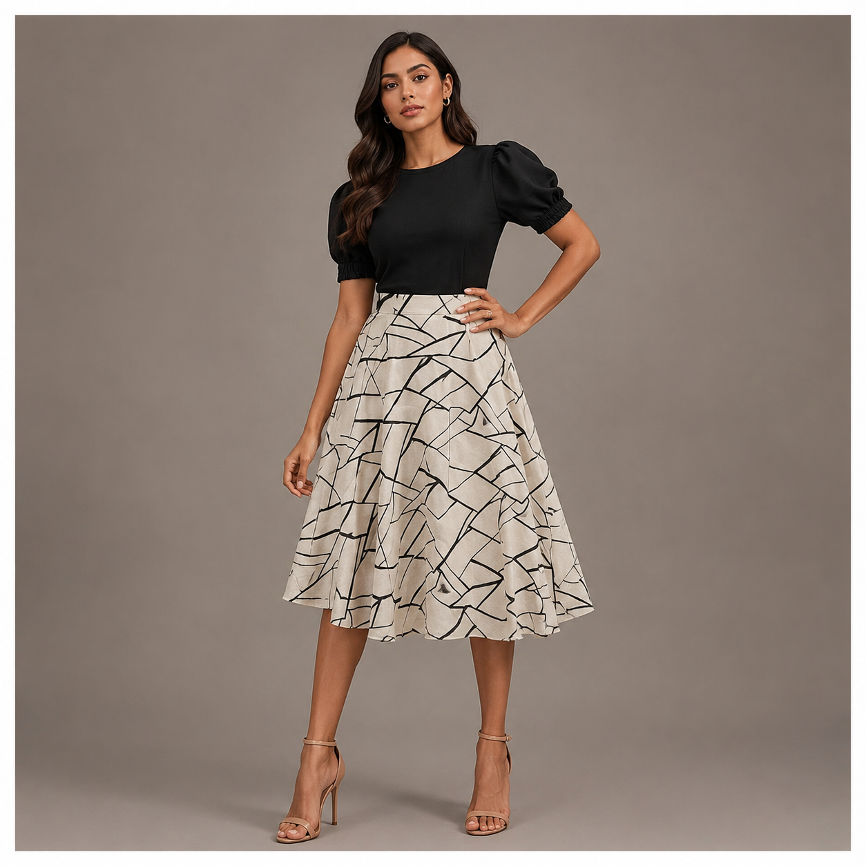 Elegant black and ivory midi dress featuring puff sleeves and an abstract printed flared skirt for a classy modern look.