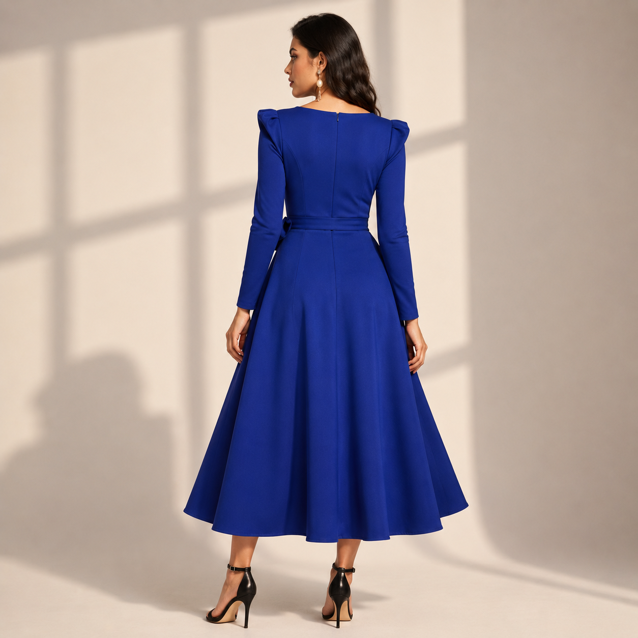 Elegant royal blue fit-and-flare midi dress with full sleeves and a chic waist-tie detail for a graceful party look.