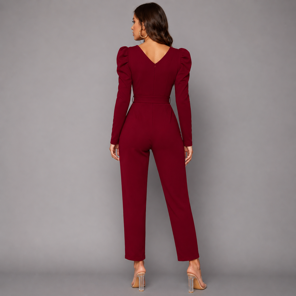 Elegant burgundy V-neck jumpsuit with puff sleeves and a sleek tailored silhouette for a sophisticated modern look.