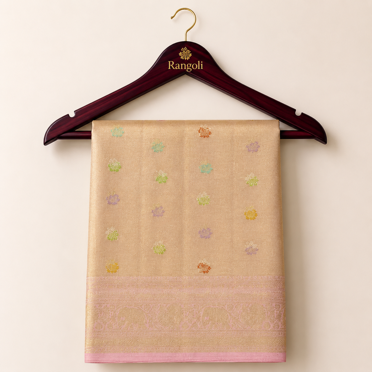 Kanchipattu rose gold saree with delicate multicolor zari motifs and a soft pink woven border for a graceful festive look.
