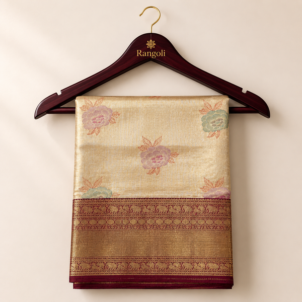 Kanchipattu champagne gold saree with soft floral zari motifs and a rich maroon woven border for a graceful festive look.