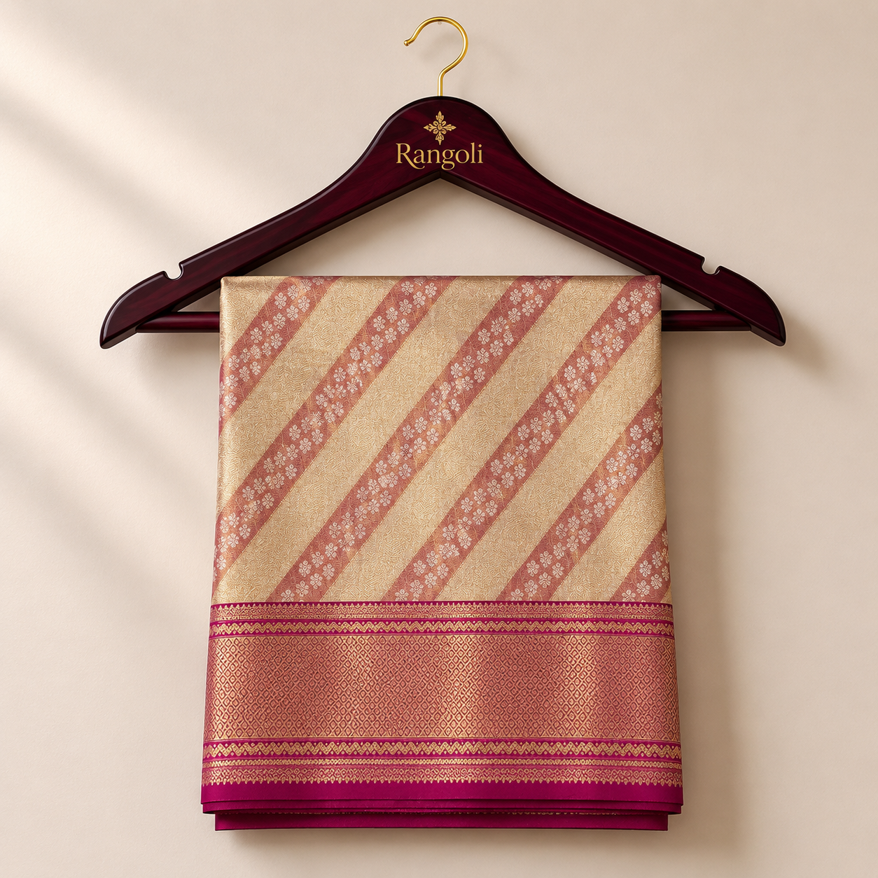 Kanchipattu gold saree with elegant diagonal zari stripes and a rich pink woven border for a graceful festive look.