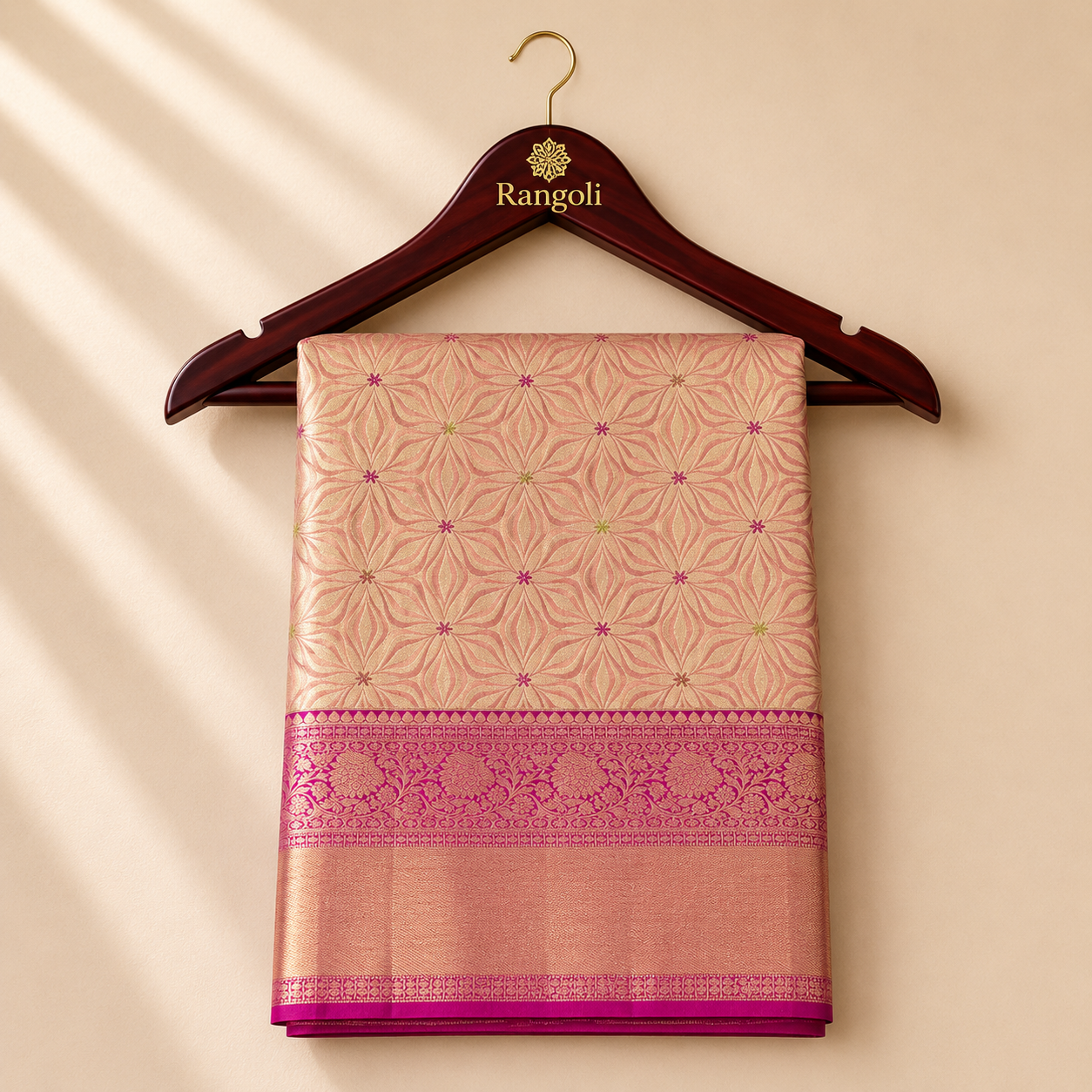 Kanchipattu peach gold saree with geometric zari weaving and a rich magenta pink zari border for a graceful festive look.