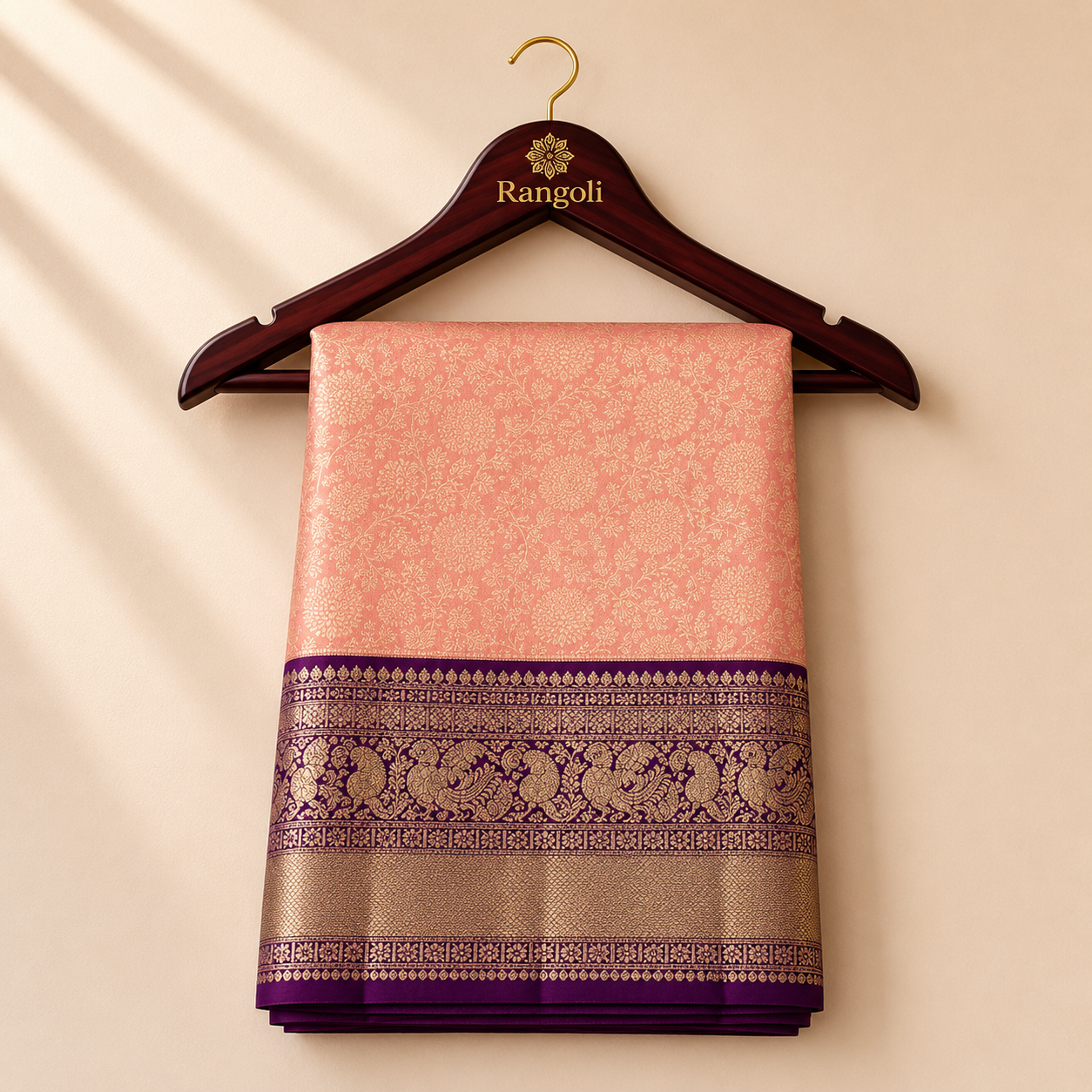 Kanchipattu peach pink saree with intricate floral zari weaving and a rich plum purple zari border for a graceful traditional look.