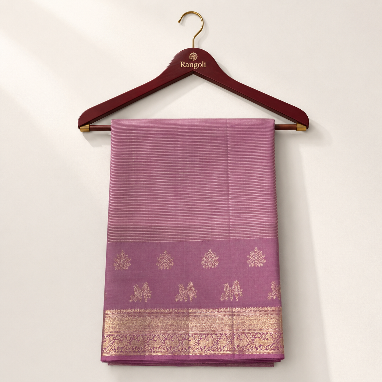 Elegant mauve Kanchipattu silk saree featuring fine striped weaving with rich zari border and traditional woven motifs for a graceful festive look