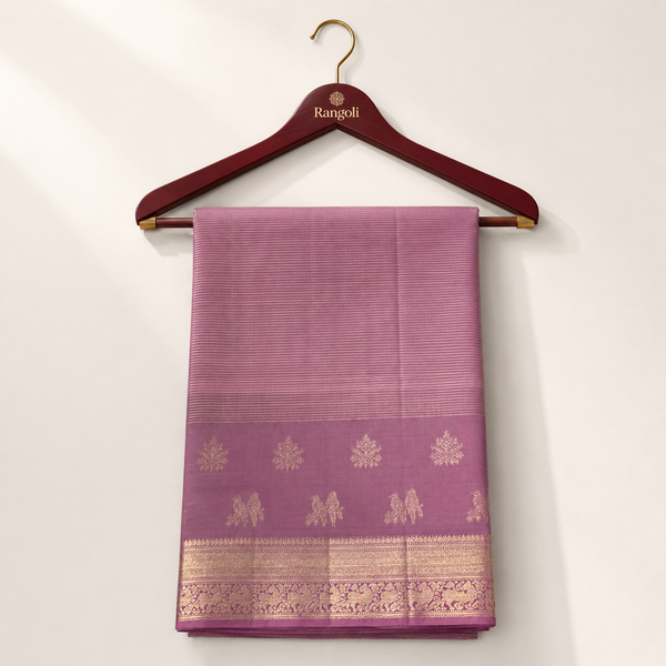 Elegant mauve Kanchipattu silk saree featuring fine striped weaving with rich zari border and traditional woven motifs for a graceful festive look