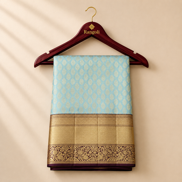 Features teardrop-shaped gold zari buttas throughout the body. Complemented by a heavy, wide wine-colored border with intricate bird and floral motifs.