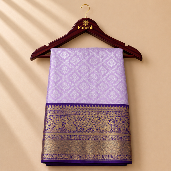 Lavender Kanchipattu saree with intricate silver zari motifs and rich royal purple zari border for a graceful festive look.