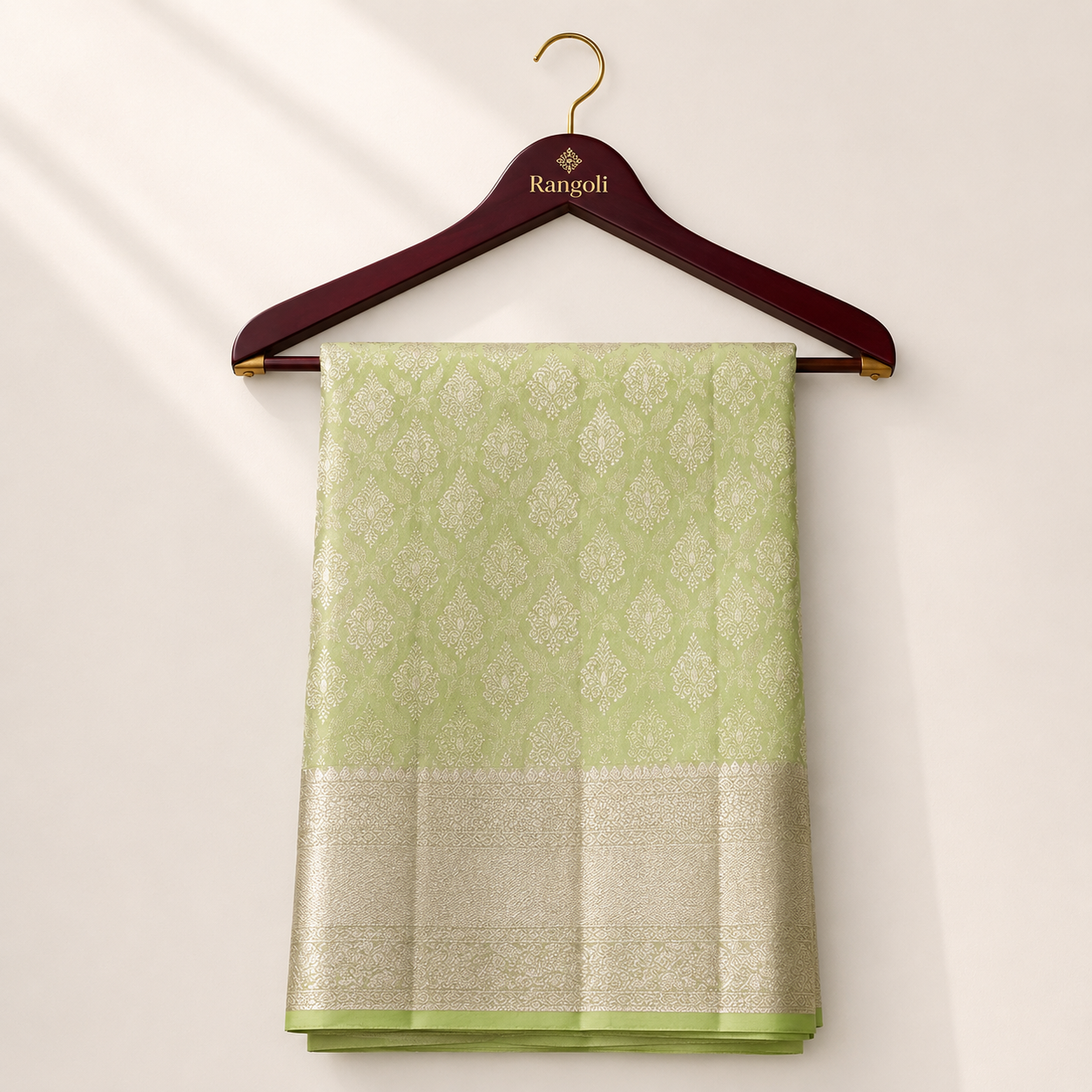 Elegant lime green Kanchipattu silk saree featuring intricate zari woven motifs with a rich golden border for a graceful traditional look.