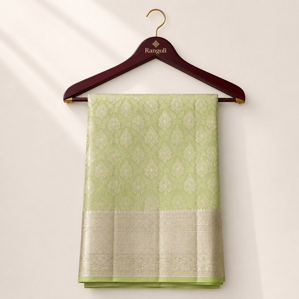 Elegant lime green Kanchipattu silk saree featuring intricate zari woven motifs with a rich golden border for a graceful traditional look.