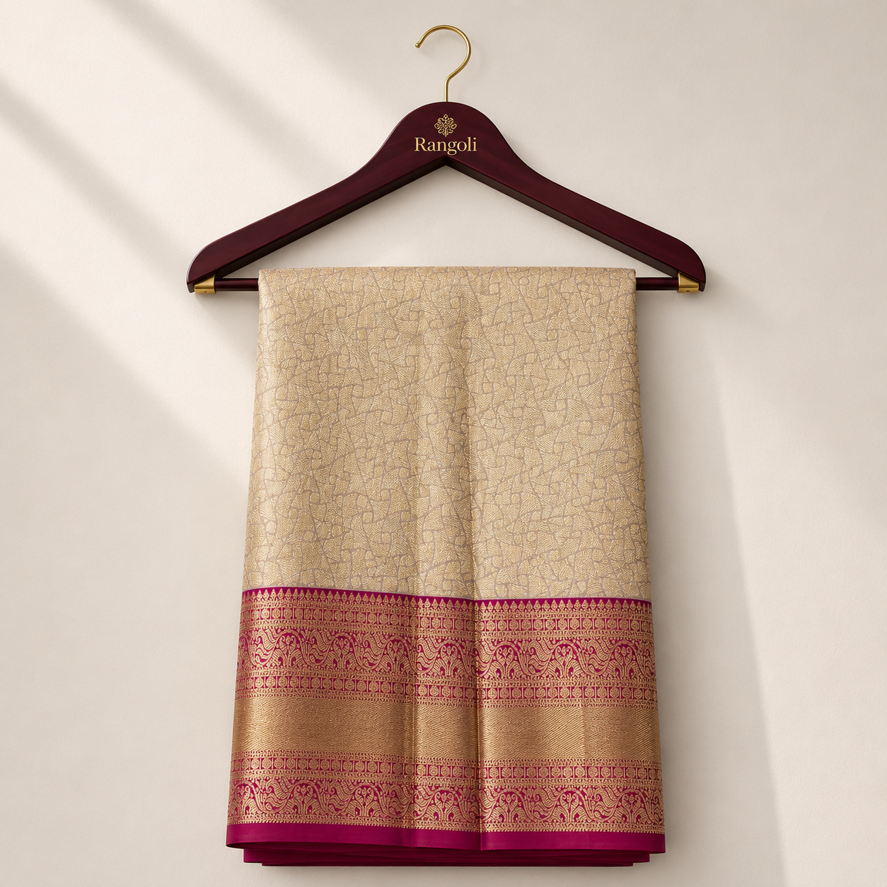 Elegant cream and magenta Kanchipattu silk saree featuring intricate geometric zari weaving with a rich golden zari border for a regal festive look.