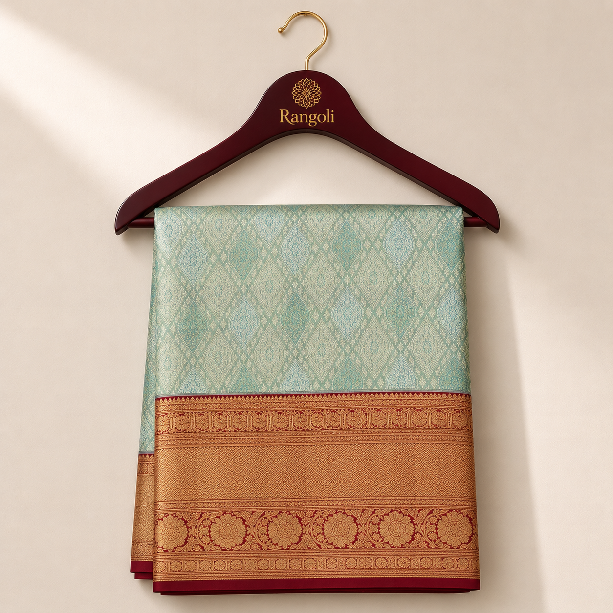 Seafoam green Kanchipattu saree with intricate gold weaving and a rich deep red zari border.