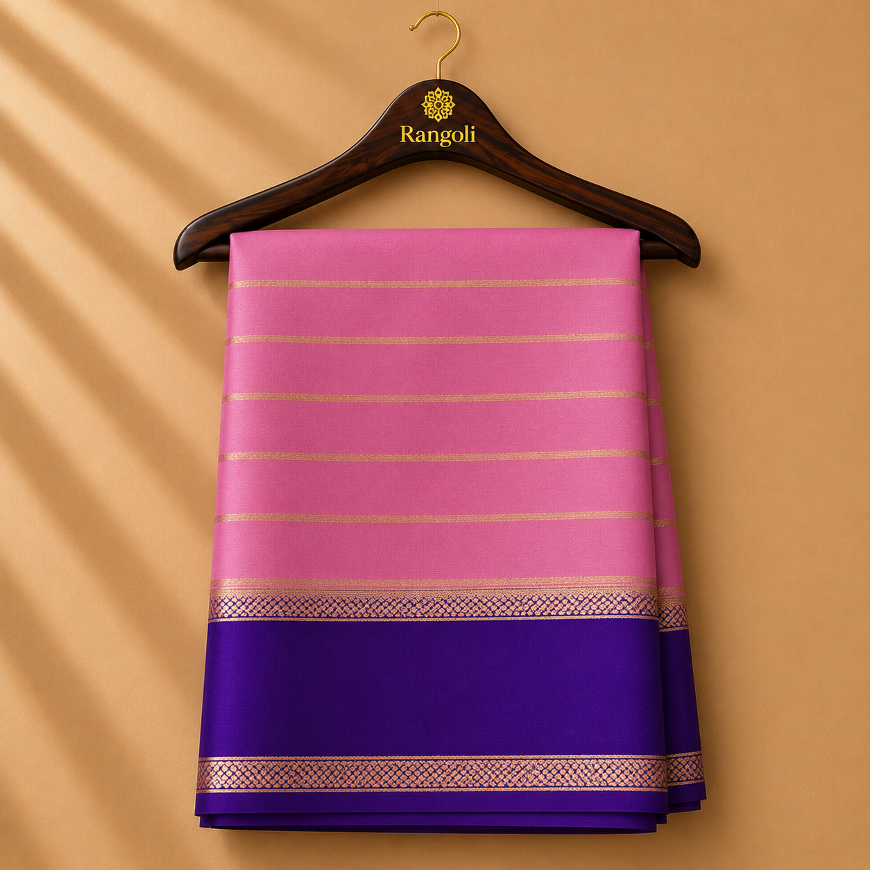 Graceful pastel pink Mysore Silk saree featuring subtle gold zari stripes and a rich royal purple border with elegant zari detailing.