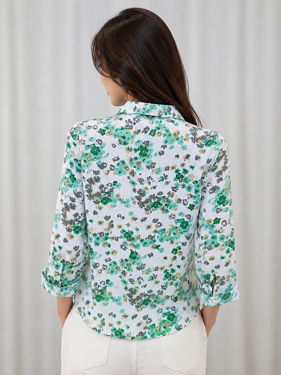 Fresh white floral shirt featuring soft green blooms, perfect for a chic and effortlessly stylish everyday look.