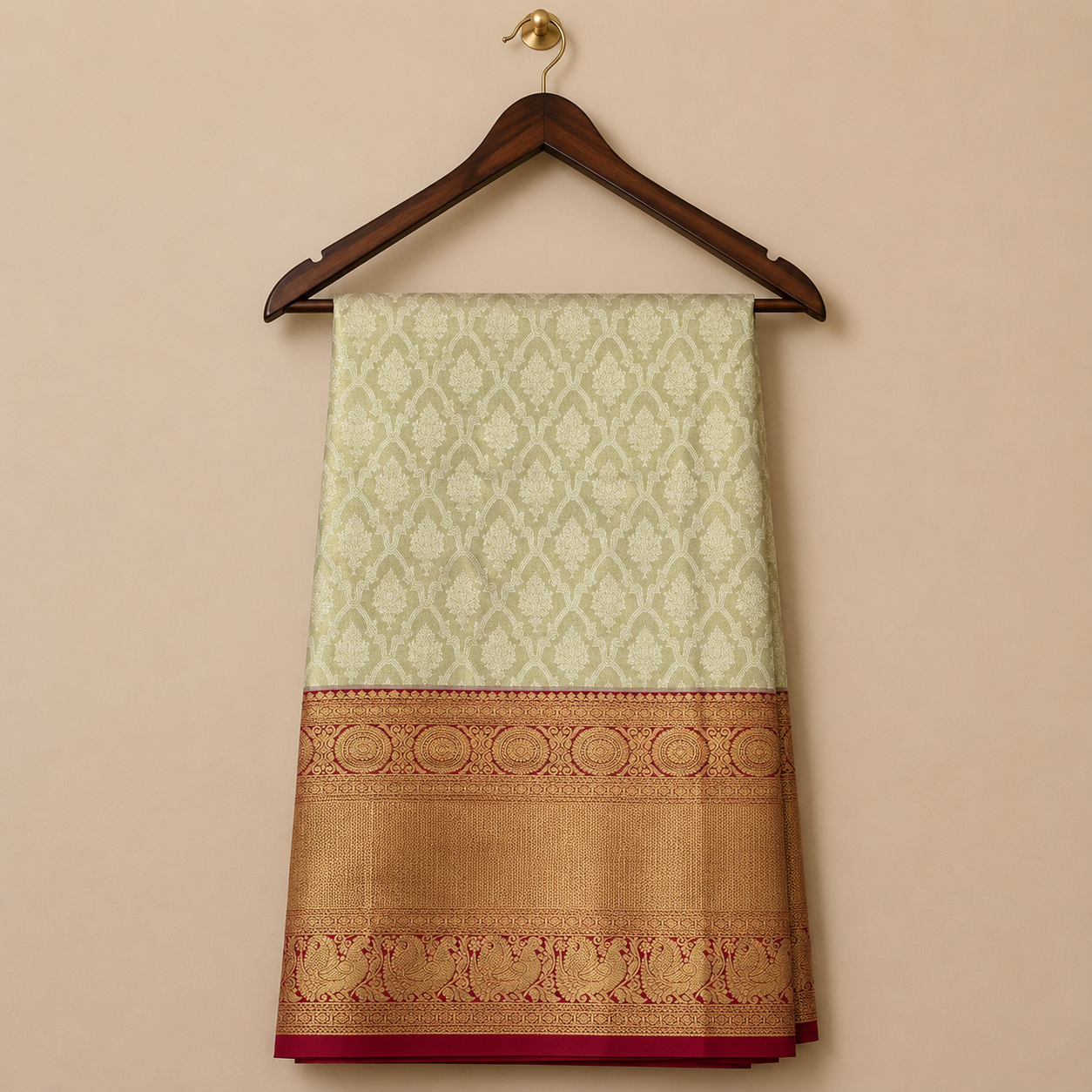 Graceful off-white Kanchipattu saree featuring intricate zari woven motifs with a rich red and gold traditional zari border.