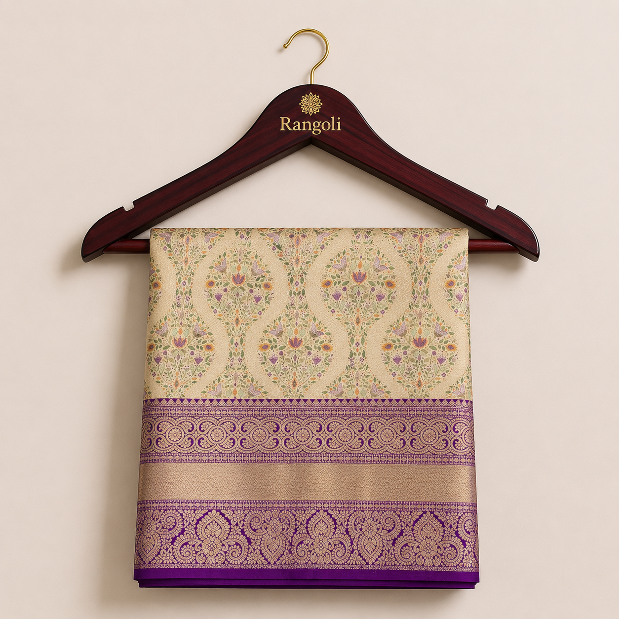 Kanchipattu gold saree with delicate floral zari motifs and a rich deep purple woven border for a regal traditional look.